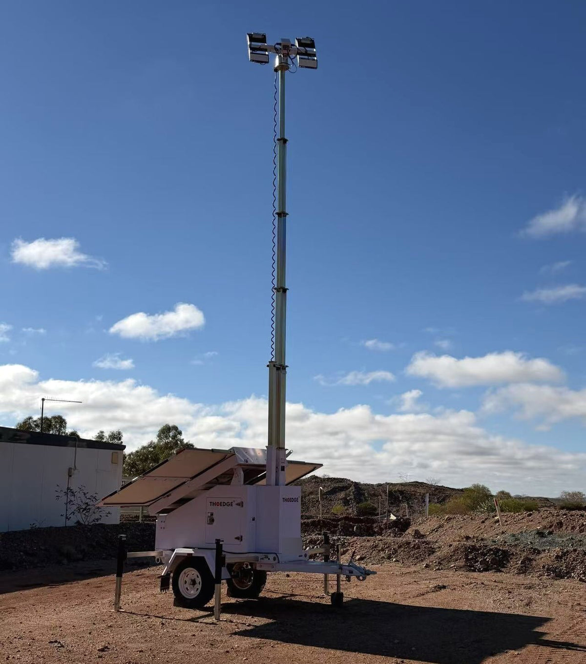 Fully deployed solar lighting tower beside a remote Australian mine road, originally delivered under The Edge branding.
