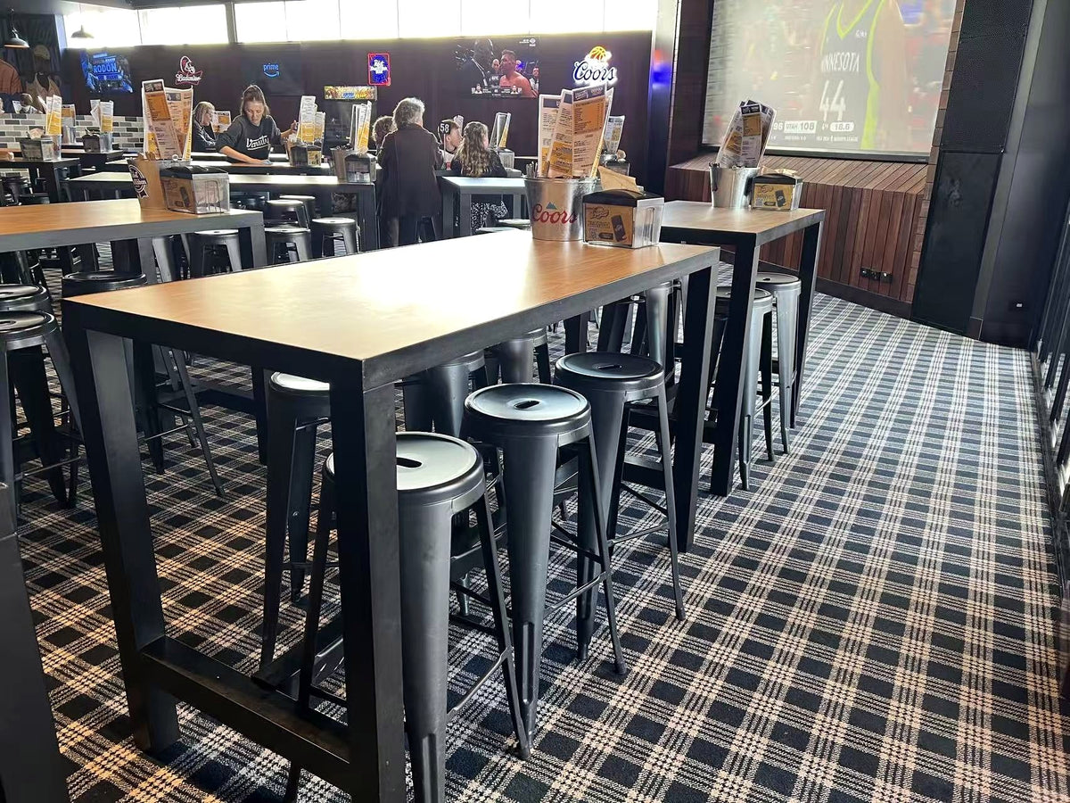 Tables, stools and seating in a completed Varsity hospitality venue supported by TL Enterprises