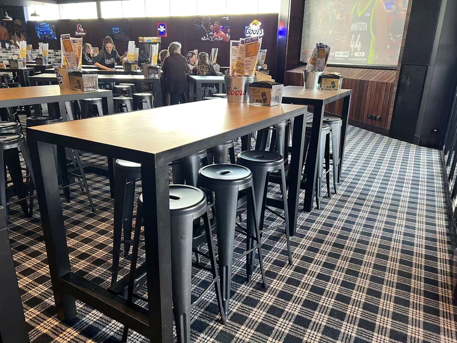Tables, stools and seating in a completed Varsity hospitality venue supported by TL Enterprises